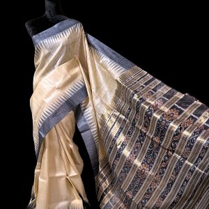 Beige tussar silk saree with temple border and golden weaved black pallu